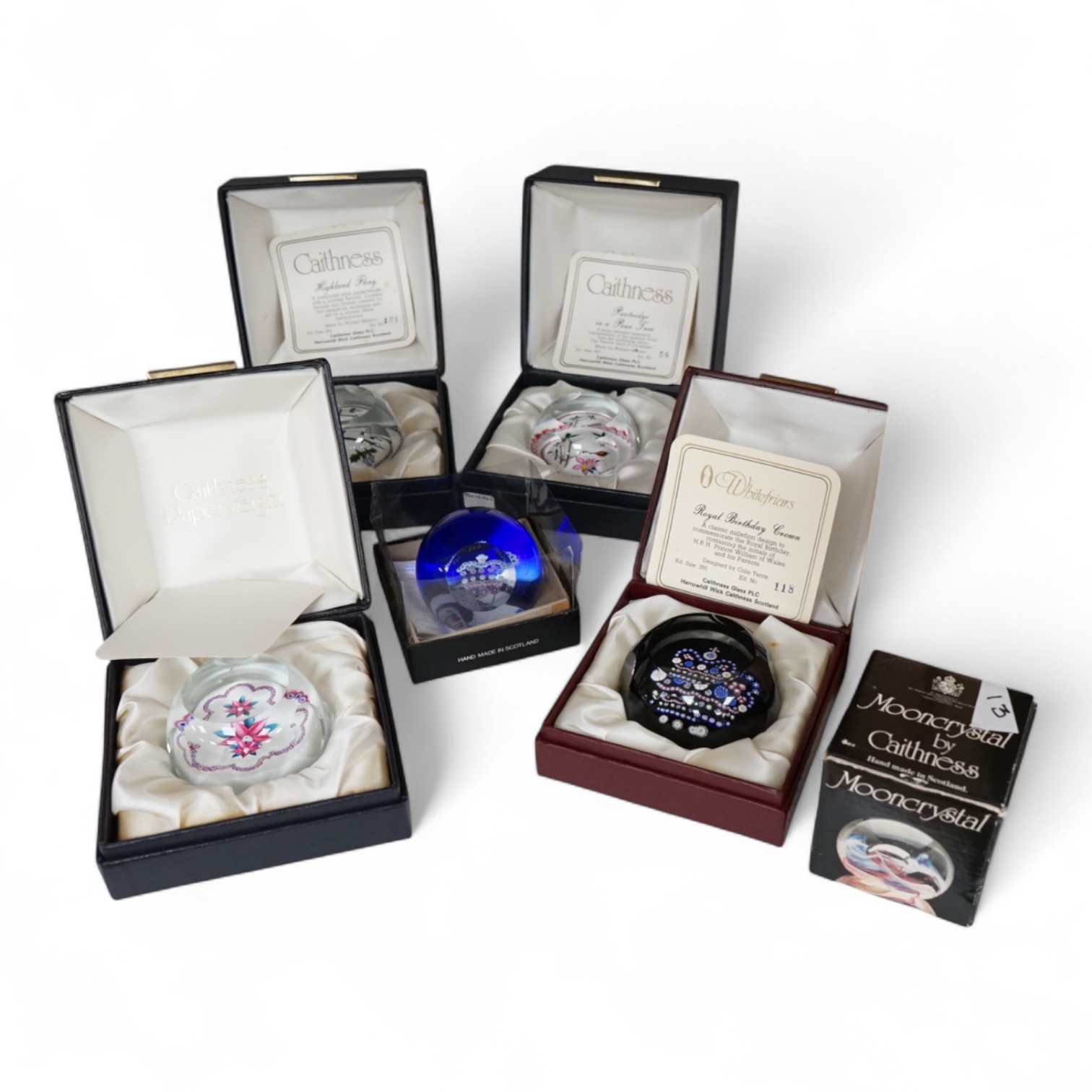 A group of five Caithness limited edition glass paperweights; highland fling, 01/250, Partridge in a pear tree, 56/500, Millefiori crown, 221/500, Rona, 56/500, Royal Birthday crown, 118/250 together with a moon crystal
